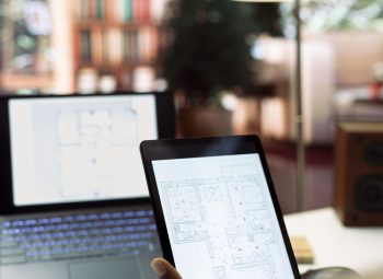 Entrepreneur conducting research and evaluating office spaces layouts on architectural blueprints, focusing on real estate investment strategy for business development. Close up.